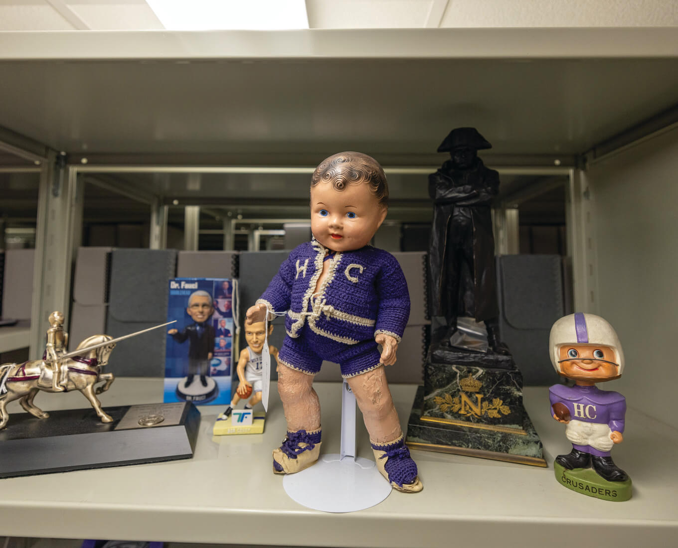 Holy Cross baby doll surrounded by other artifacts