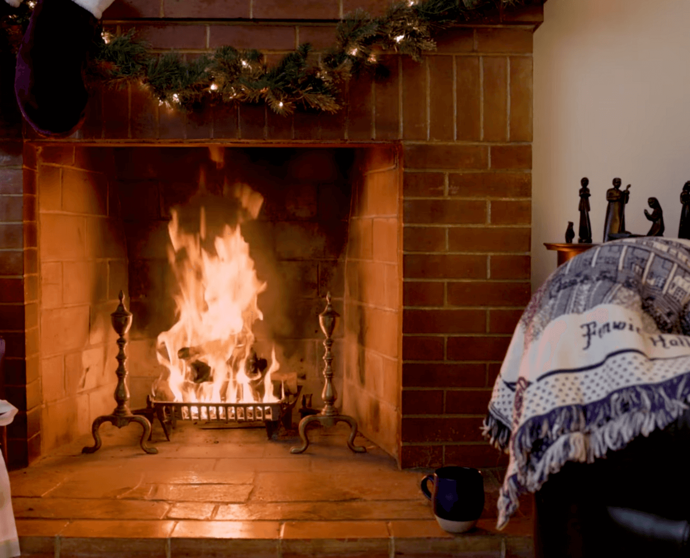 Fire in a fireplace decorated for a Holy Cross-themed Christmas