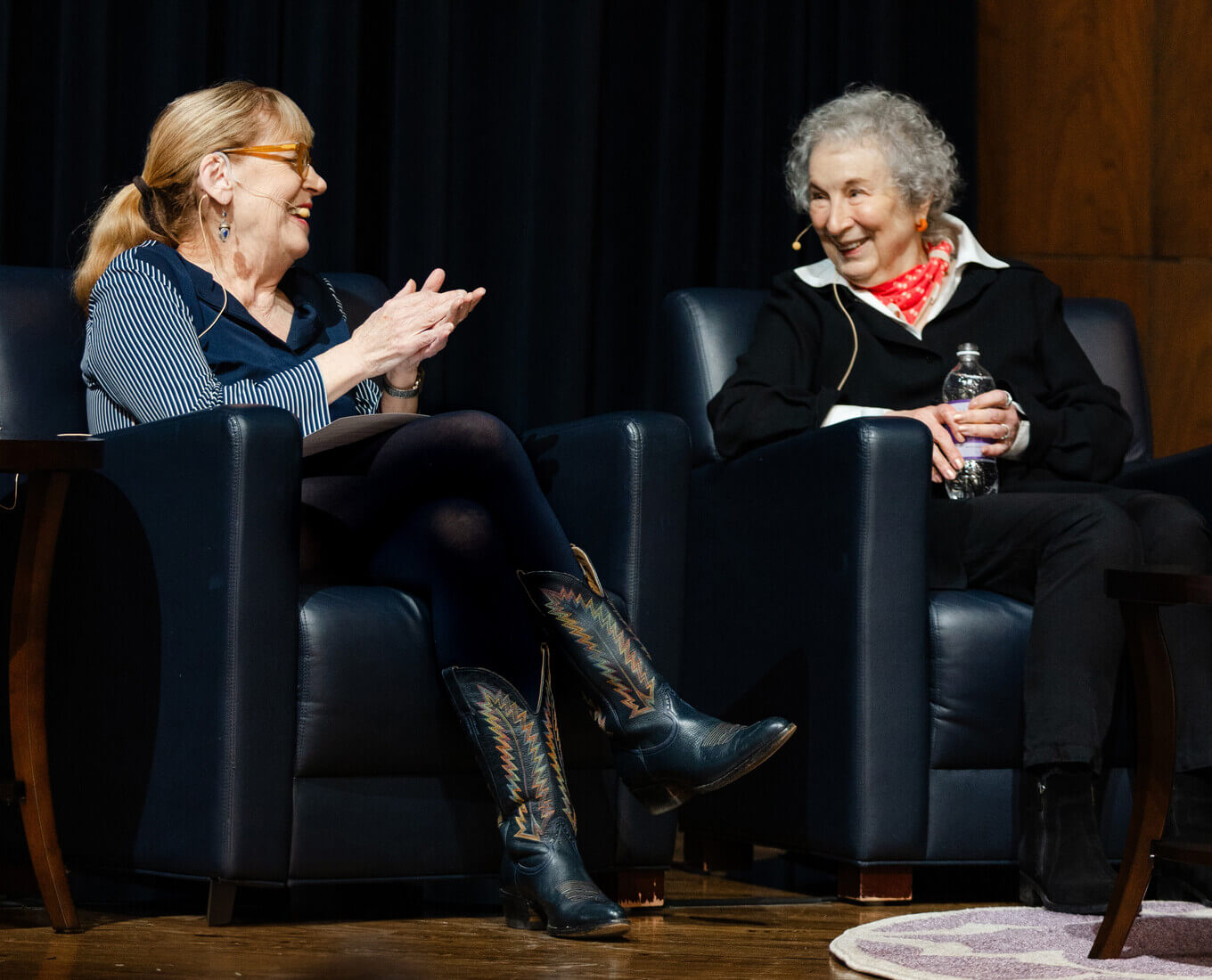 Two women sit in chairs talking