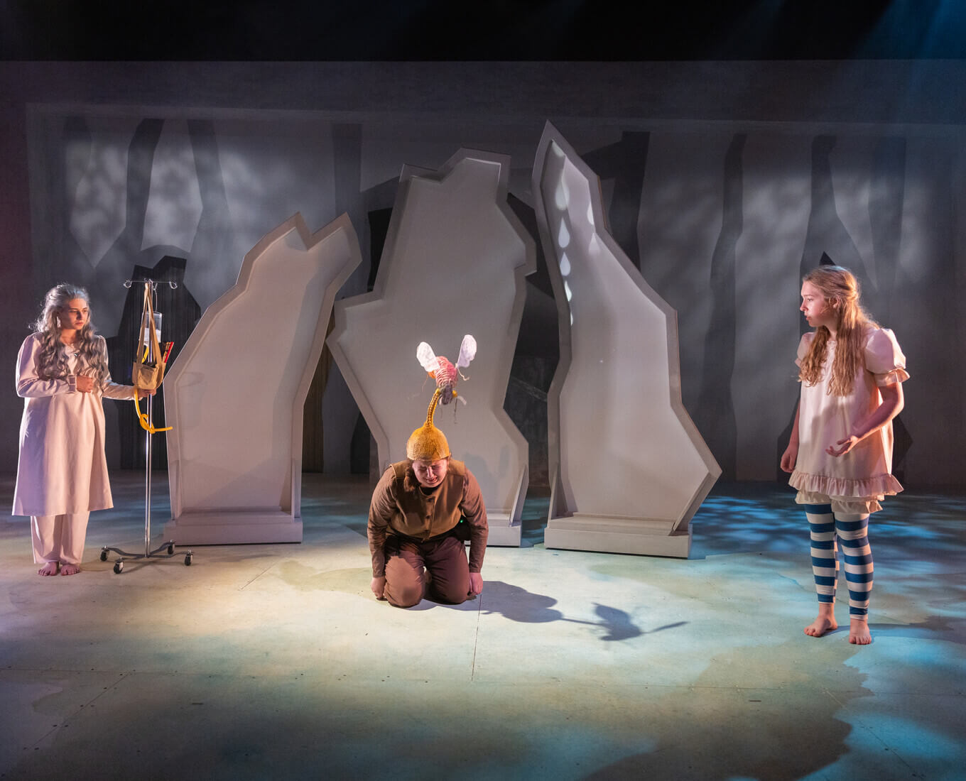 Three students on a stage