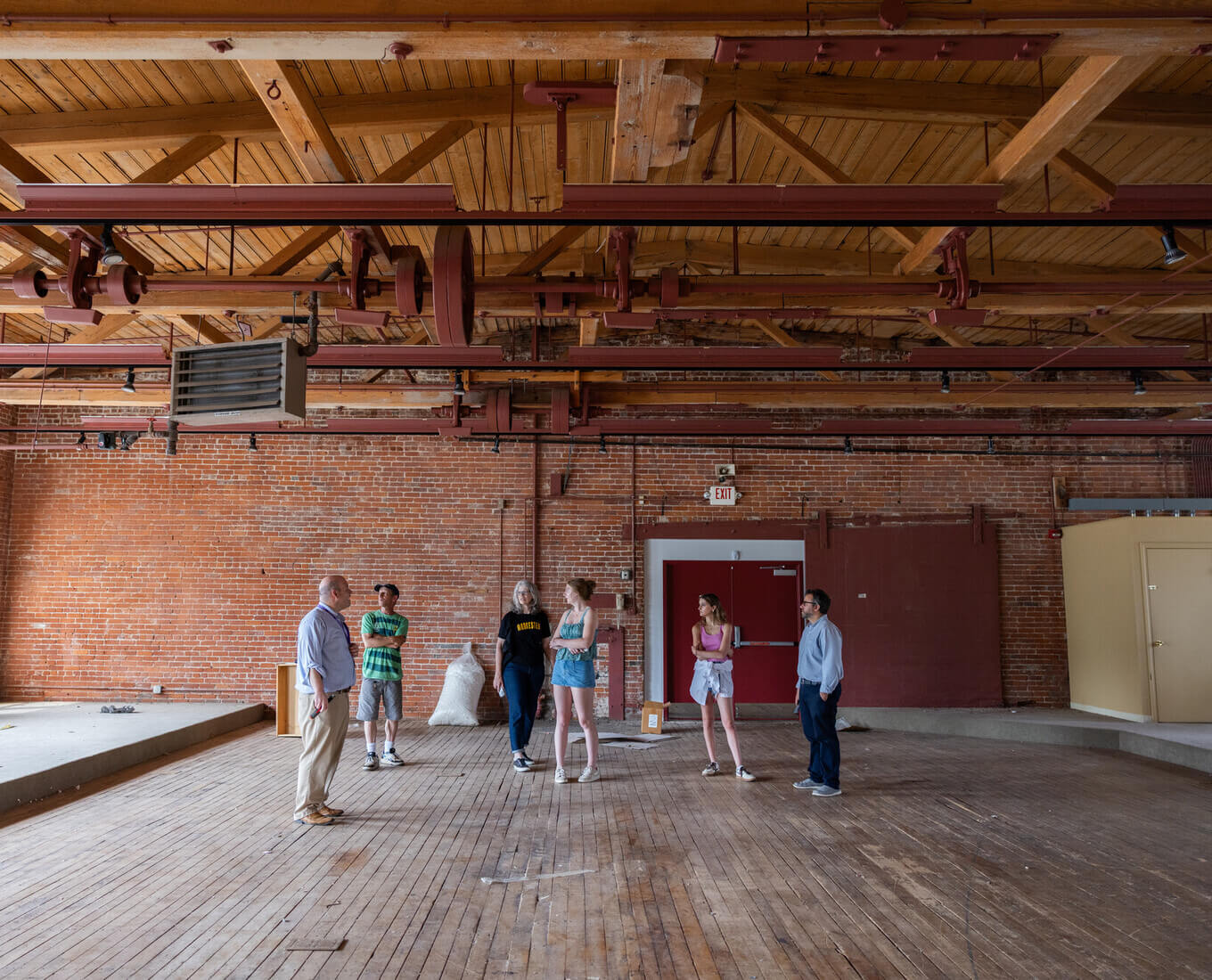 People standing in an old mill building