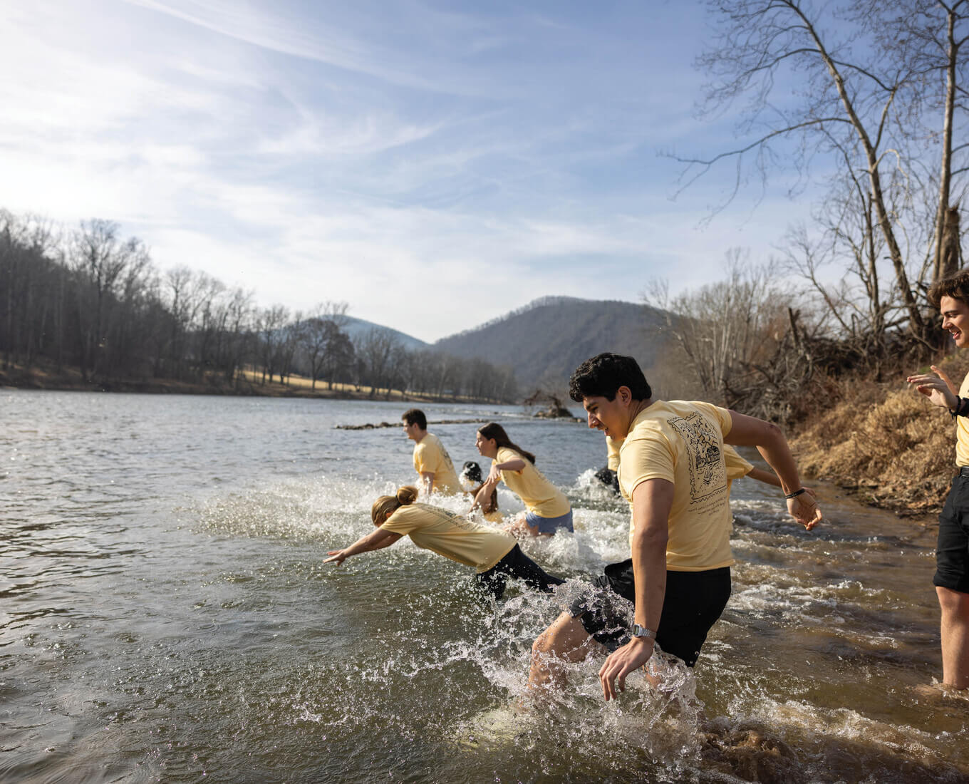 Students diving into a river