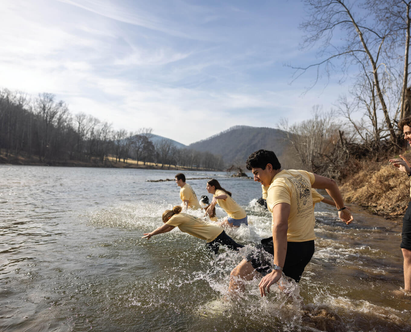 Students diving into a river