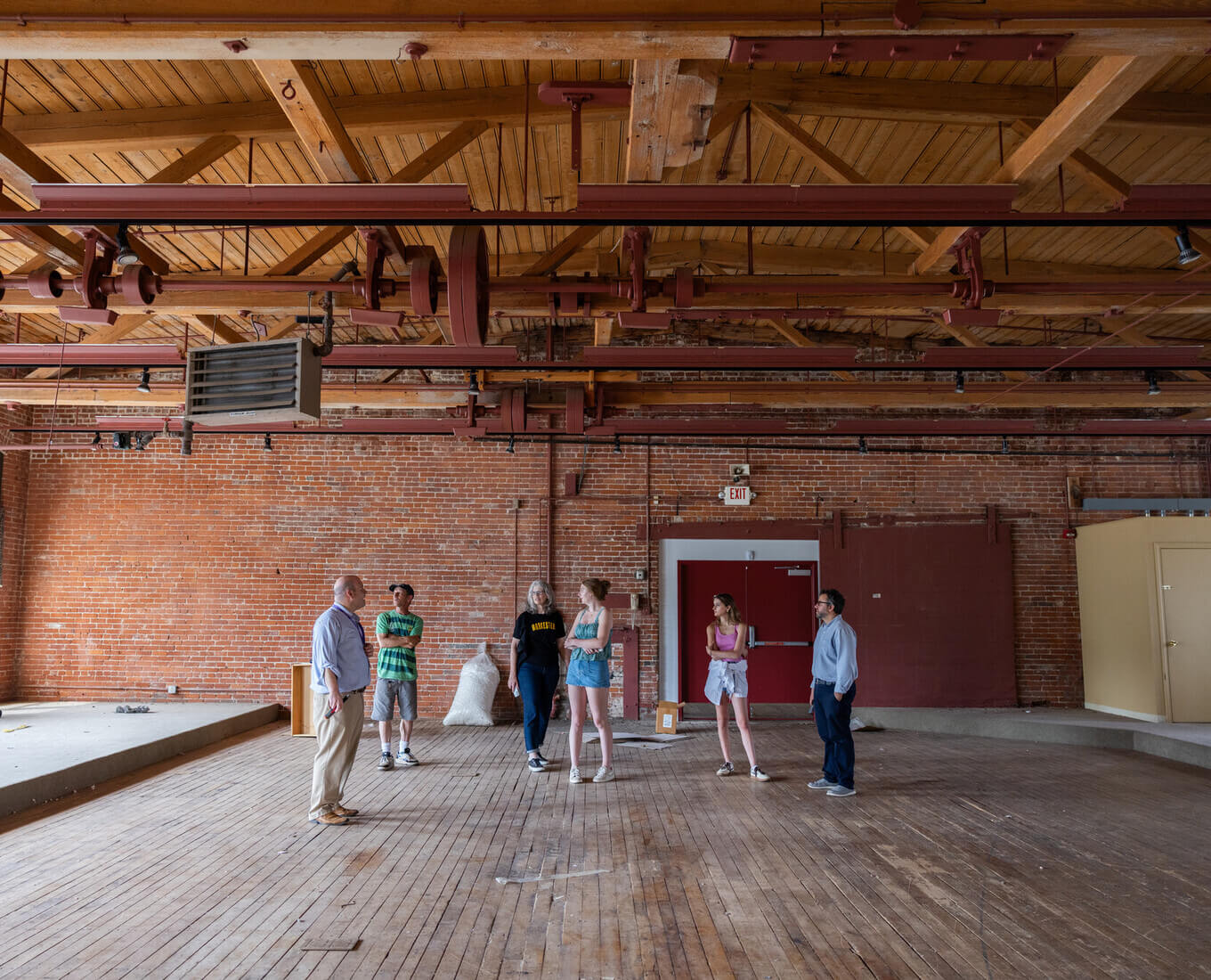 People standing in an old mill building