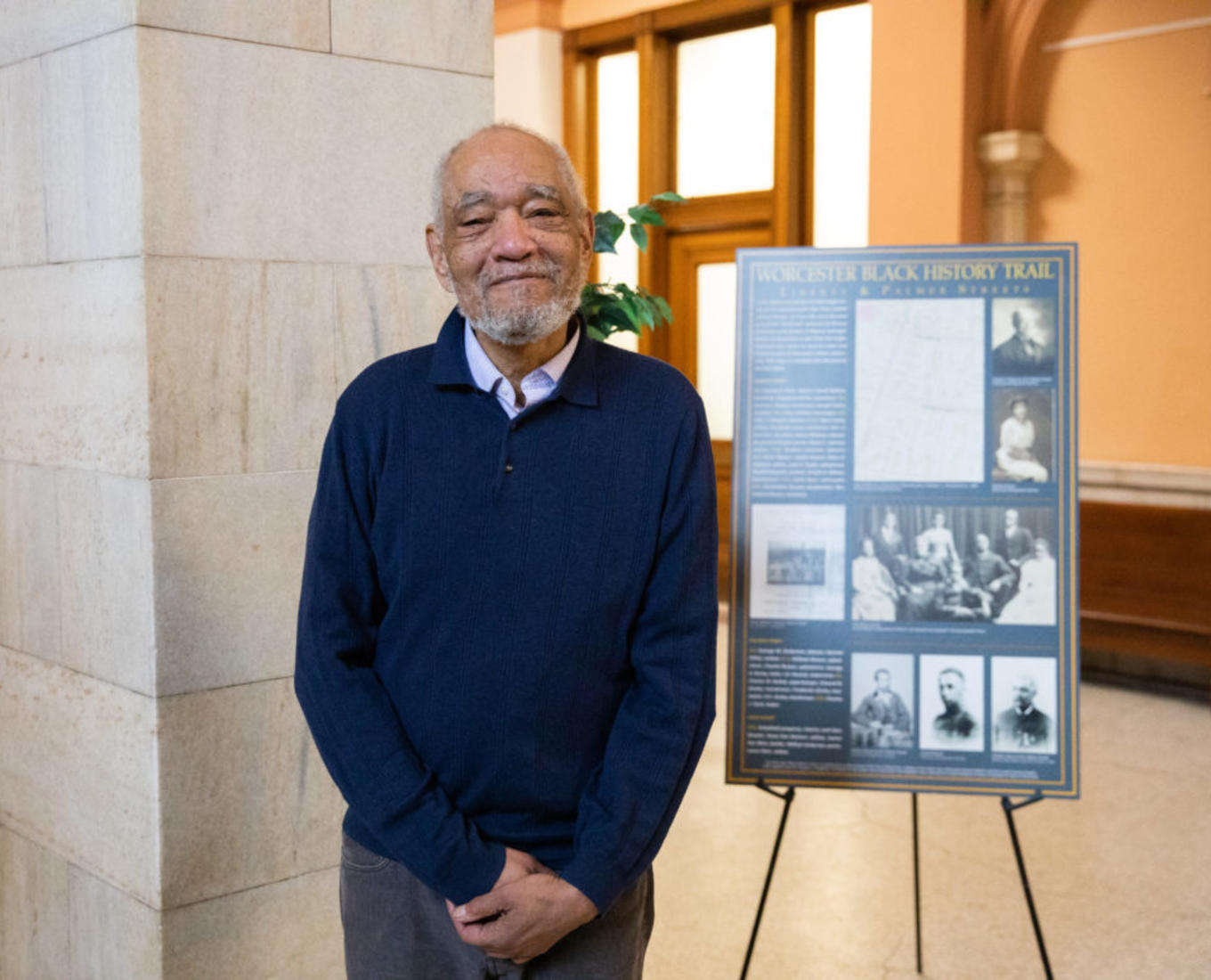 Professor Tom Doughton in front of the City Hall exhibit as part of Worcester's Black History Month celebration.