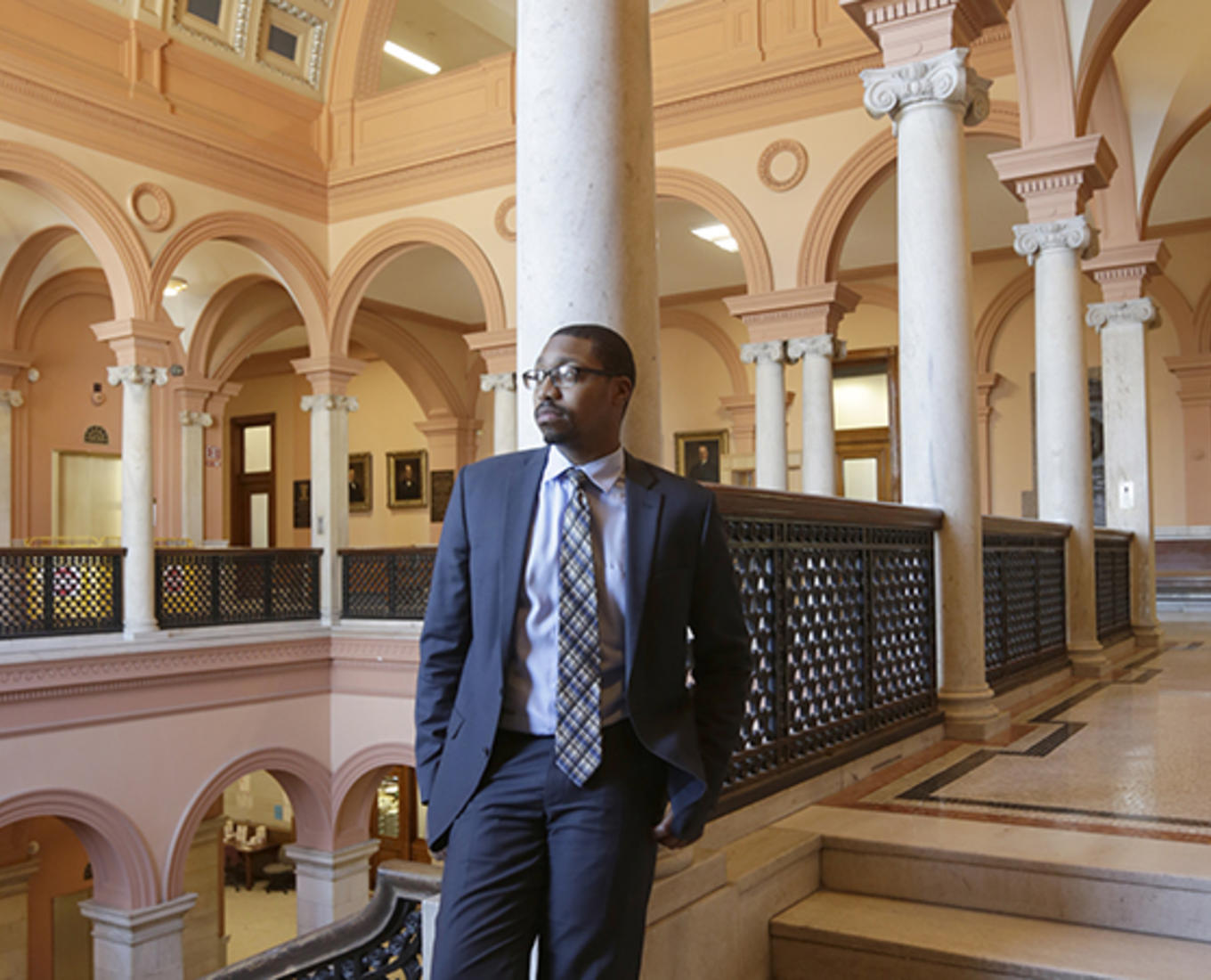 Che Anderson '11, project manager with the City of Worcester stands at Worcester City Hall. Photo by Tom Rettig