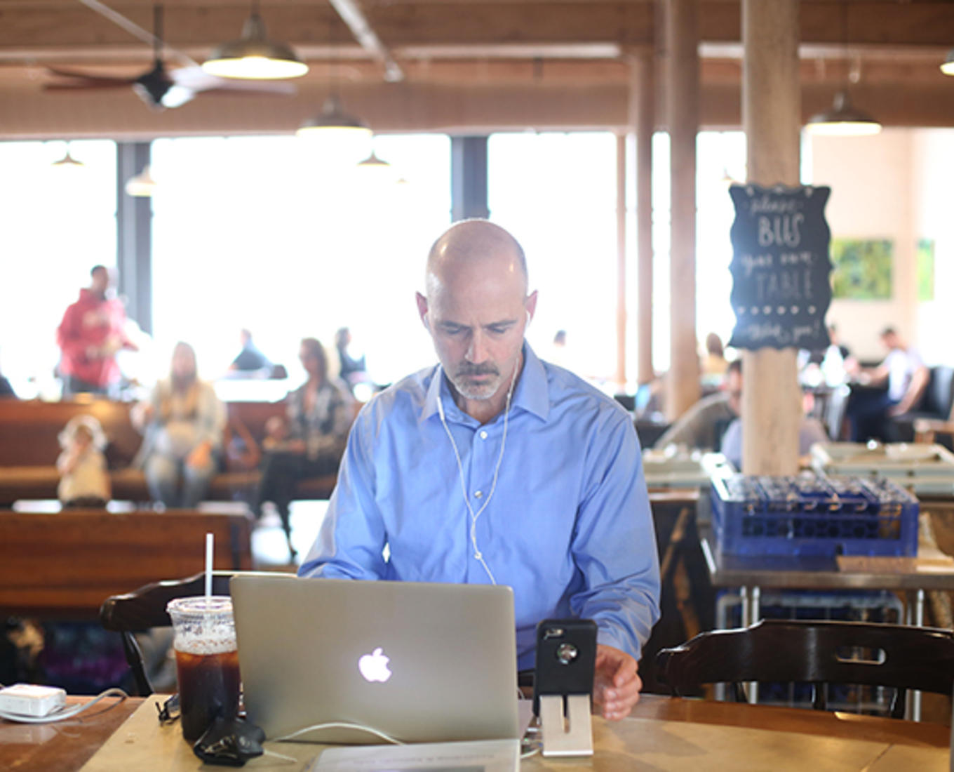Ed O'Donnell, associate professor of history at Holy Cross, is seen here working on his podcast "In The Past Lane" at BirchTree Bread Company in Worcester. Photo by Tom Rettig