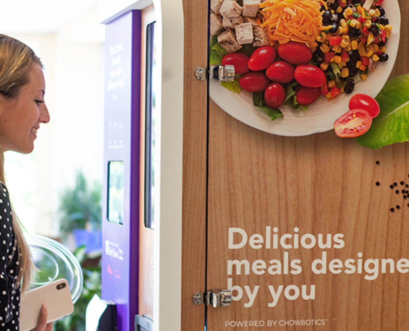 Image of student using Sally the Food Robot. Photo courtesy of Holy Cross Dining