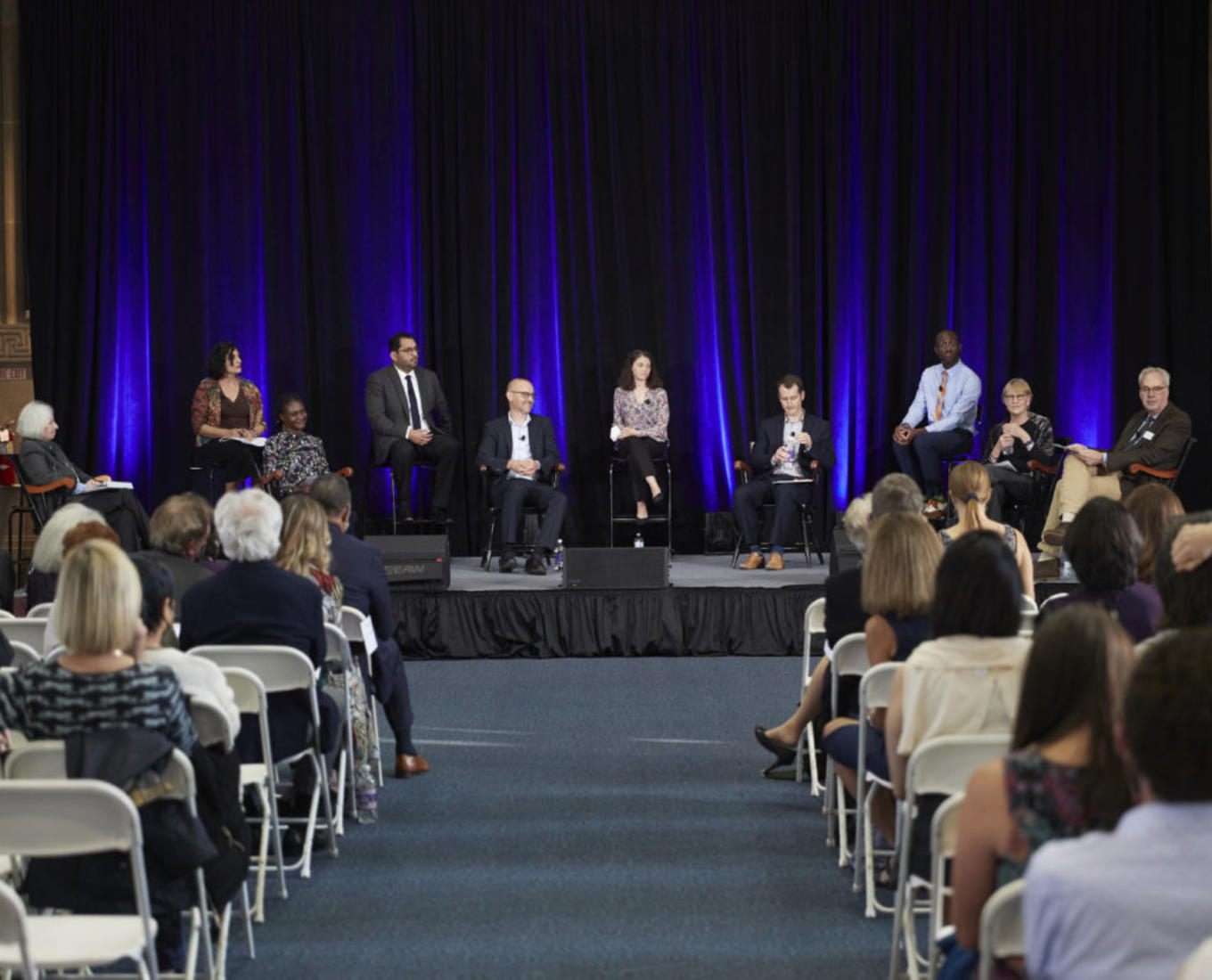 Nine Holy Cross faculty members are participating in a panel discussion at a faculty symposium held in Dinand Library. Photo by Michael Quiet