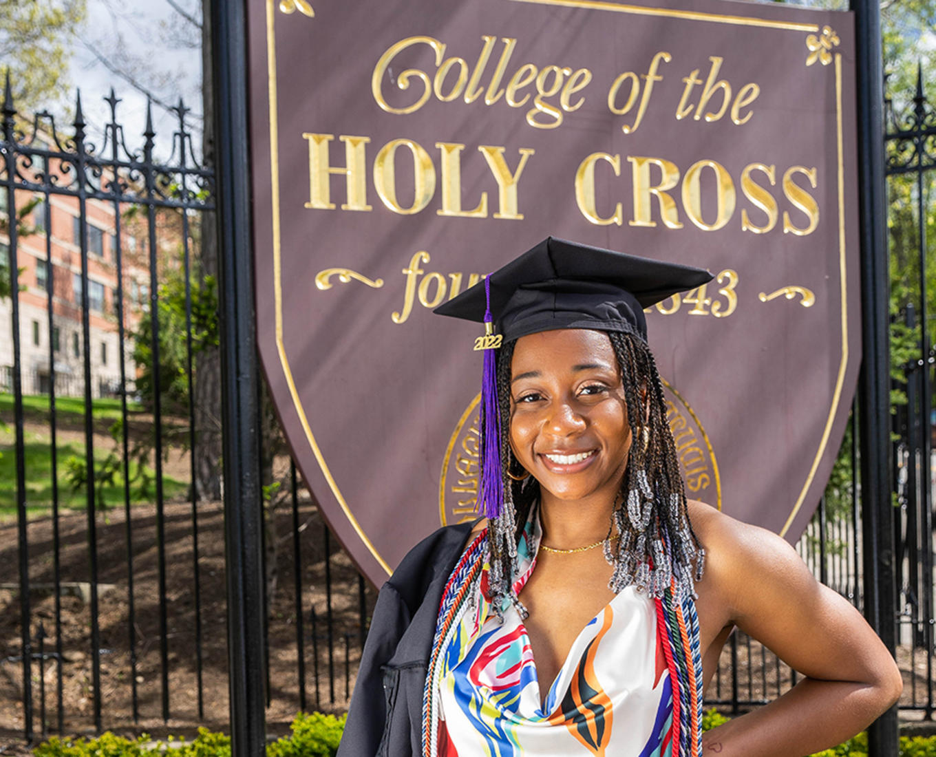 Meah Austin Class of 2022 standing in front of College of the Holy Cross sign.
