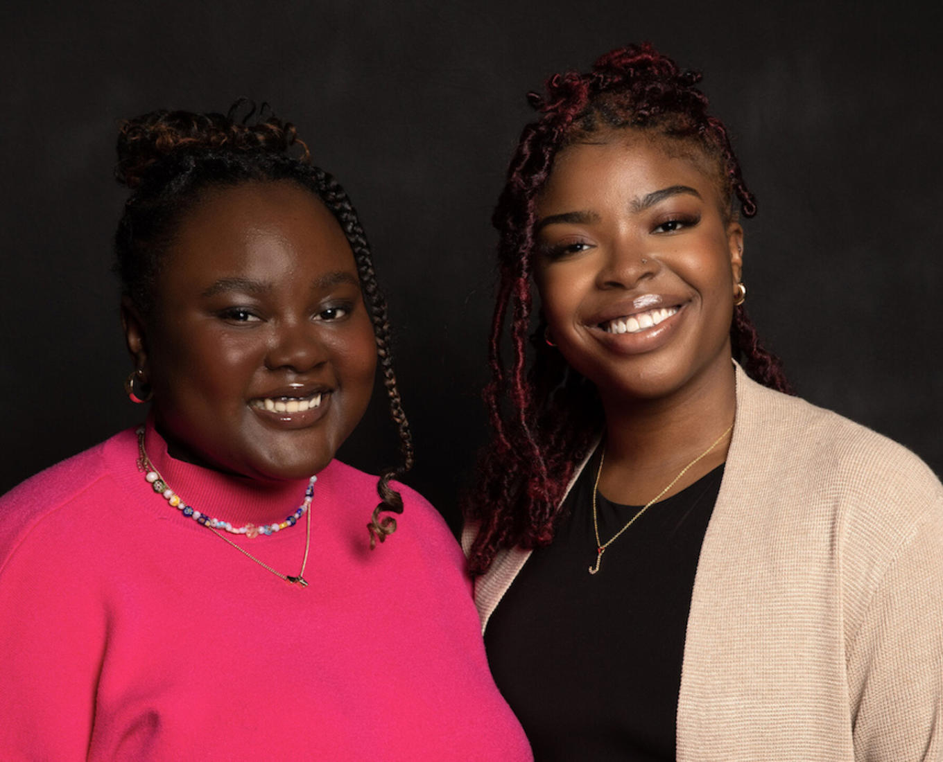 Two women smile for a portrait