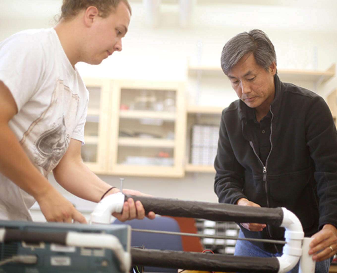 Samuel Habein '17 and Professor and Department Chair Tomohiko Narita build a cosmic ray telescope during Summer Research 2015.