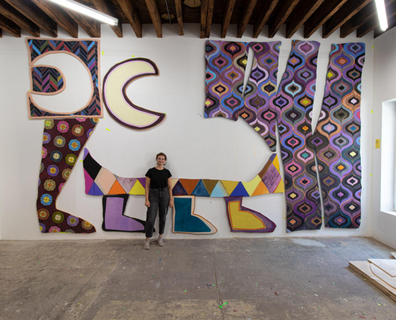 Justine Hill '08 in front of “The Travelers” (2022) in her studio in Brooklyn, NY. Courtesy Denny Dimin Gallery, New York.