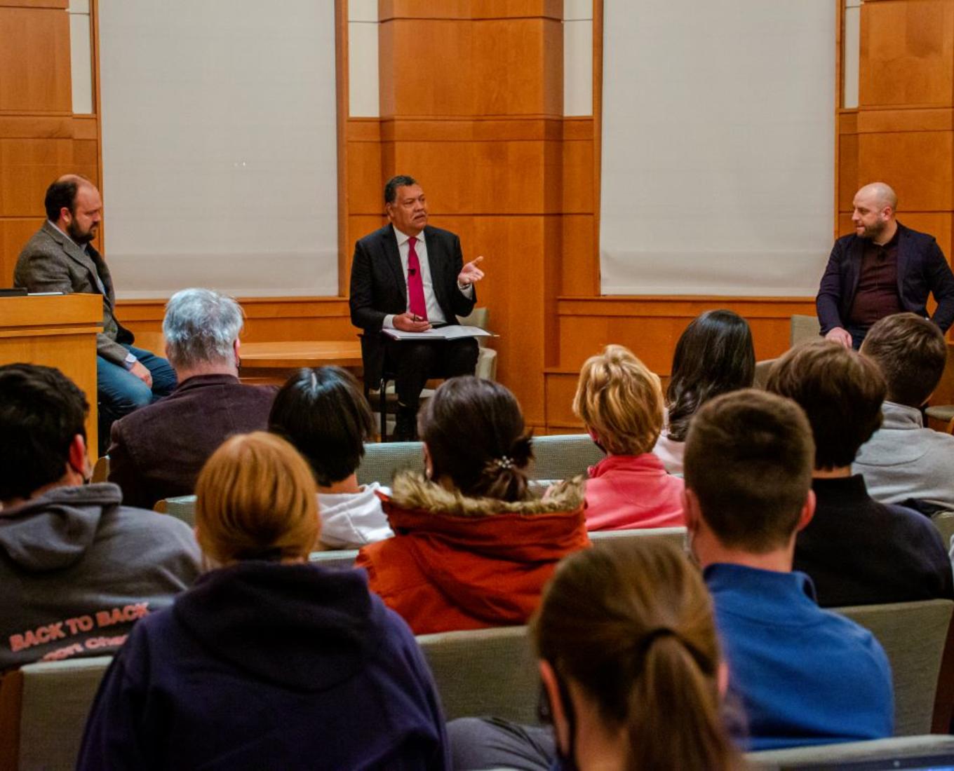 Ross Douthat of the New York Times, President Vincent Rougeau, and Matthew Sitman, associate editor of Commonweal Magazine, sit in front of a crowd in Rehm Library