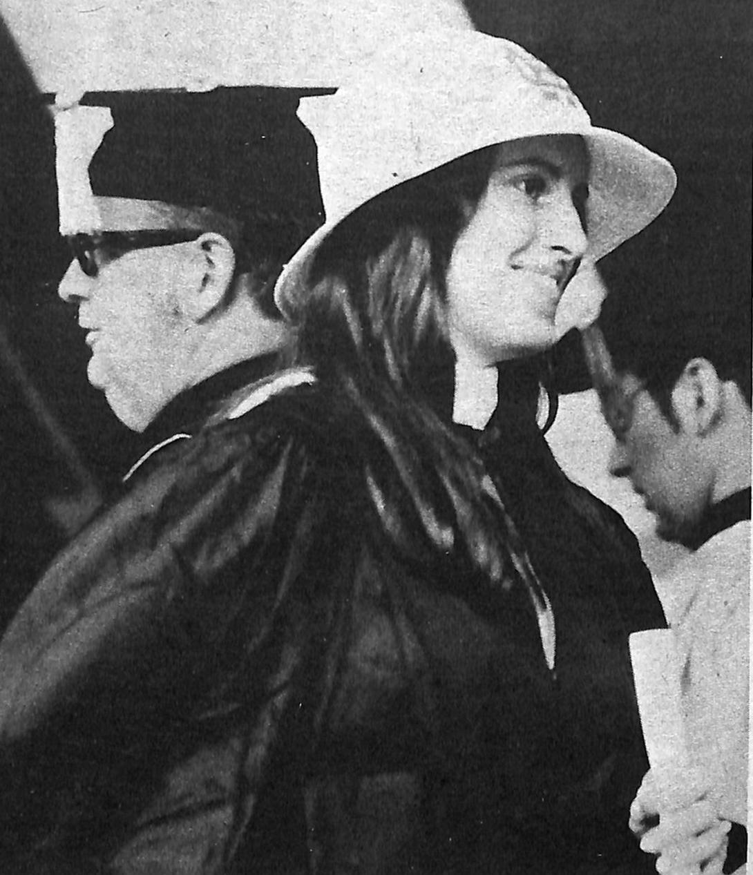 Joanne C. Bell ’74 becomes the first woman to graduate from Holy Cross as she receives her diploma from Fr. Brooks on May 31, 1974