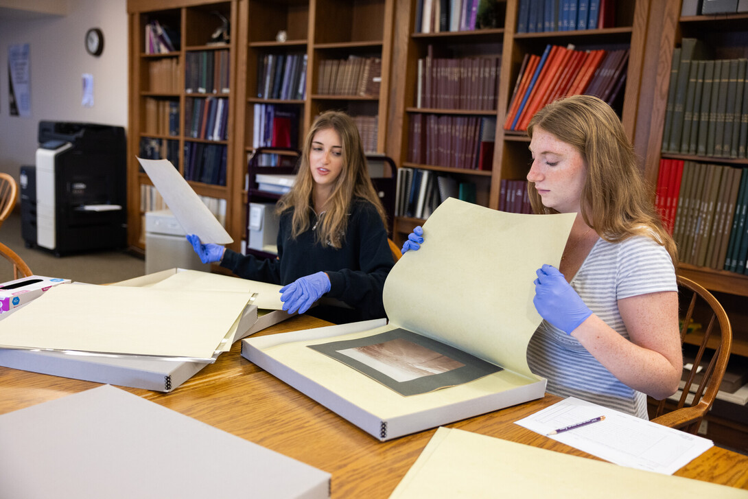 Two students looking at archival materials